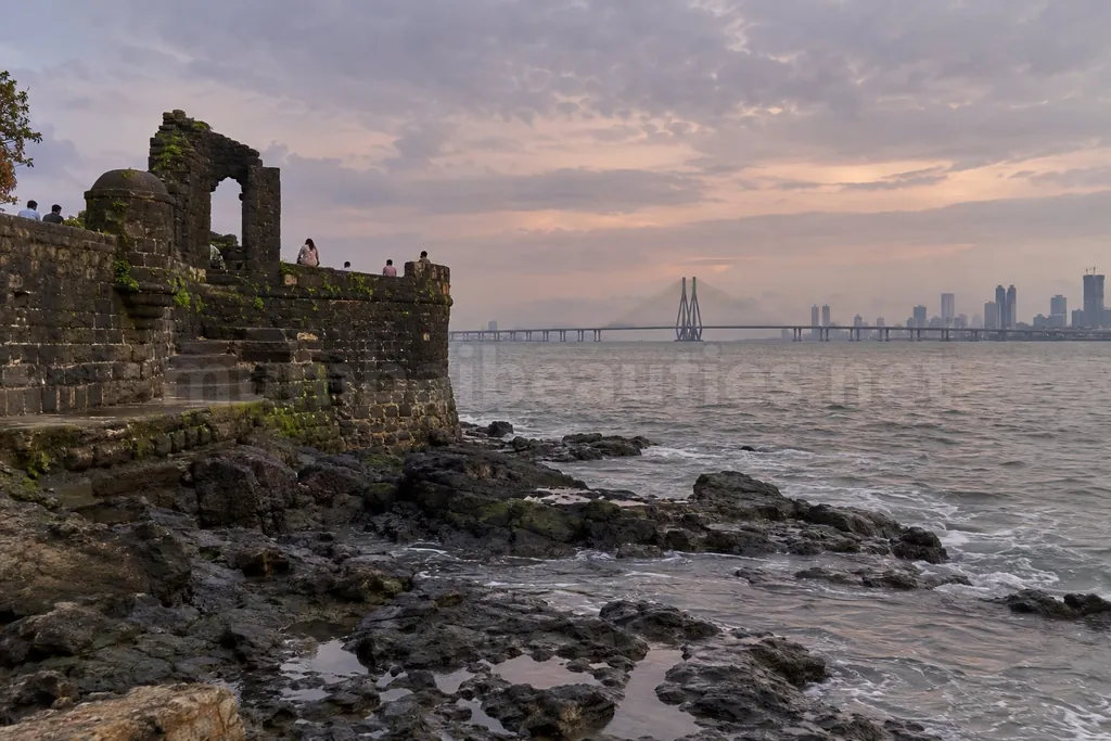 Bandra Fort's old stone walls at sunset, Sea Link cables across the water – Bandra escorts
