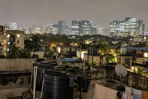 BKC office towers at evening, seen from Bandra East across a wide road: incall and outcall near BKC