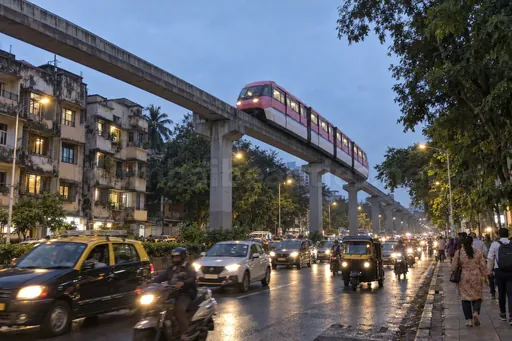 Mumbai Monorail train on its concrete beam above a Chembur road at dusk, Chembur escorts service