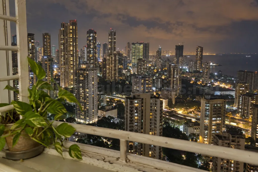 Mumbai at night from a high flat window, lit towers by the sea – Mumbai escort locations